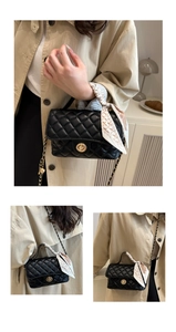 Detail of black quilted leather handbag with gold twist lock and elegant silk scarf handle