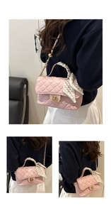 Detailed view of pink quilted crossbody bag with silk scarf handle and gold twist lock