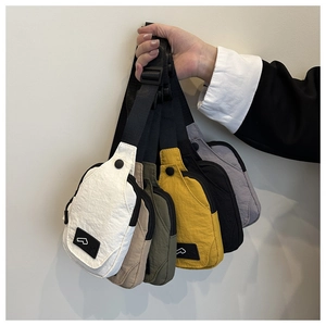 Detailed close-up of nylon chest bags in multiple colors with adjustable shoulder straps