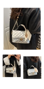 Detailed close-up of silver quilted texture with golden twist lock and silk scarf handle