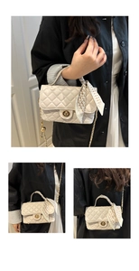 Detail of quilted beige crossbody bag featuring gold twist lock and scarf-wrapped chain
