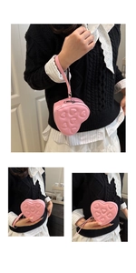 Close-up of pink heart-shaped mini bag with quilted heart pattern and silver zipper detail