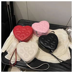 Detailed view of heart quilted PU leather purses in red, pink, black and beige colors