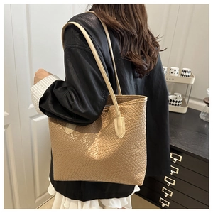 Lifestyle shot of large woven tote bag being worn on shoulder showing its size and fit
