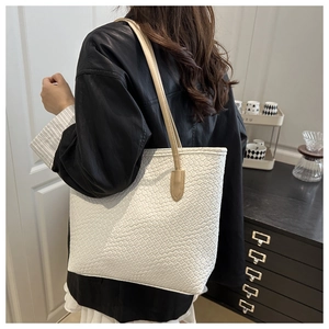 Detail of the white woven texture and large capacity structure on this winter tote bag