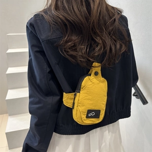 Minimalist yellow nylon crossbody chest bag shown on model for outdoor casual wear