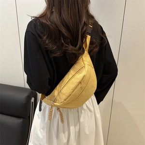 Yellow corduroy crescent chest bag with striped texture and adjustable shoulder strap