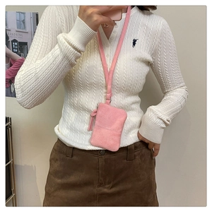 Detail of light pink faux suede mini neck pouch with fringe and long lanyard