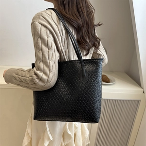 Classic black woven leather tote bag with large capacity and cylindrical shoulder straps