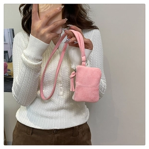 Pink faux suede mini neck pouch showing the soft texture and wristlet strap detail