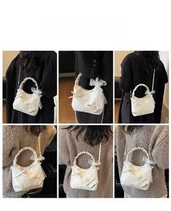 Detailed views of beige bow shoulder bag with lace ribbons and ruched handle detail