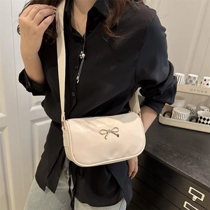 Minimalist cream shoulder bag with golden bow and wide strap for women