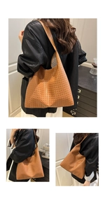 Detail of vintage brown woven leather tote showing rich texture and large capacity style