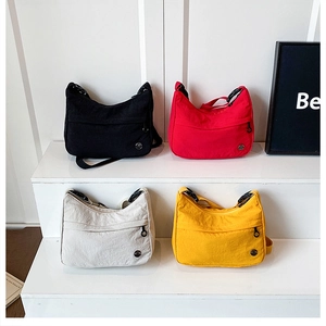 Front view of nylon crossbody bags in black, red, beige, and yellow with adjustable straps