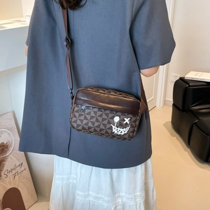 Minimalist square crossbody bag with brown checkerboard pattern and graffiti smiley face