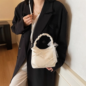 Creamy white pleated cloud shoulder bag with bow accents and ruffled handle for women