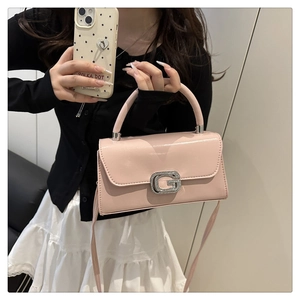 Close-up of pink leather handbag featuring a silver crystal-encrusted G metal buckle