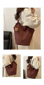 Detail of dark brown faux suede tote bag with matching leather pouch charm accessory