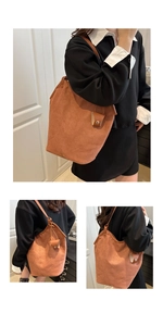 Brown suede tote bag with slim shoulder straps and a matching small leather pouch charm