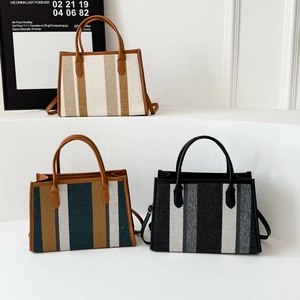 Three stylish striped tote bags in beige and blue featuring leather handles and straps