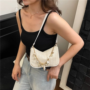 Straw shoulder bag with pearl sea shells and gold chain accents for summer outfits