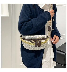 Detail of beige canvas crossbody bag with horse logo, gold chain, and woven strap