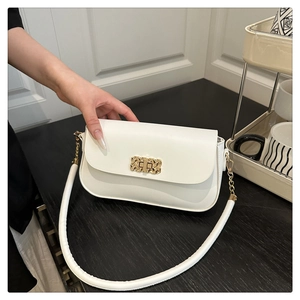Close-up of a white rectangular bag with an elegant gold woven texture metal buckle