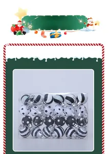 Detail of 3cm black and white Christmas ornaments with stripes and dots in clear packaging