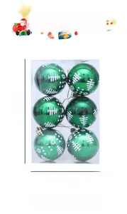 Close-up of green Christmas balls with white tree and snowflake patterns in a clear box