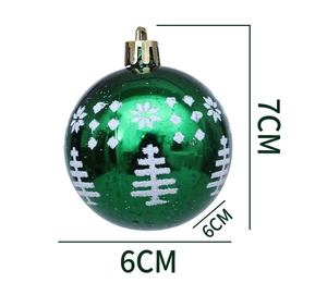 Detail view of 6cm green Christmas ball with white glitter pine tree and snowflake patterns