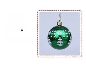 Close-up of a 6cm green Christmas ball with white snowflake and tree patterns
