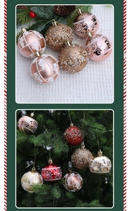 Detail of rose gold and red Christmas baubles with glitter patterns on pine branch