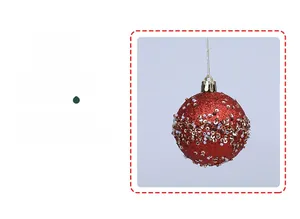 Detail of red Christmas ornament ball with glitter sequins and gold hanging string