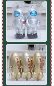 Detail view of silver astronaut and golden zeppelin Christmas ornaments in clear packaging