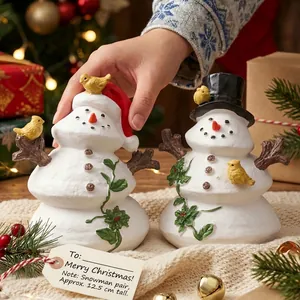 Pair of festive resin snowman figurines with red and black hats for Christmas decor