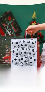 Set of 12 black and white football Christmas ornaments in a clear gift box display