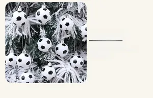 Close-up of black and white soccer ball Christmas tree ornaments with silver hanging caps
