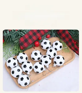 Set of 12 soccer ball Christmas ornaments with silver strings on a festive background