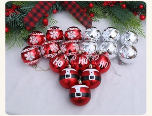 Detail view of red and silver Christmas balls with snowflake and Santa belt patterns