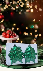 Detail of leaf-shaped Christmas ornaments with gold glitter finish in clear packaging