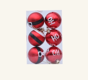 Detailed view of red Christmas ornaments with HO HO HO text and Santa belt patterns