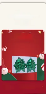 Detail of green leaf-shaped Christmas ornaments with gold glitter in clear gift box