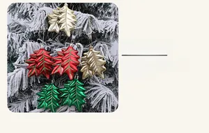 Close-up of holly leaf Christmas ornaments with glitter edges and metallic finishes