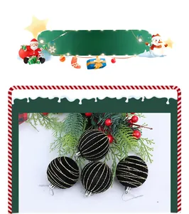 Close-up of four matte black Christmas ball ornaments with spiral gold glitter accents