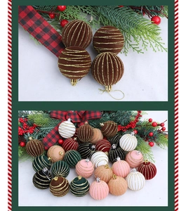 Close-up of velvet 6cm Christmas ball ornaments with gold glitter stripes and pine accents