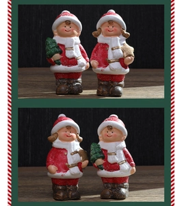 Nahaufnahme der handbemalten Weihnachtsfiguren aus Keramik als Junge und Mädchen Set