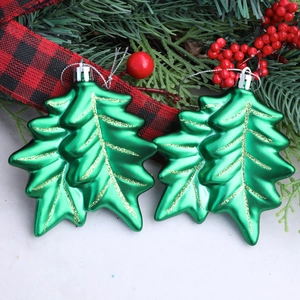 Glittering green holly leaf Christmas tree ornaments with gold accents in a festive wreath