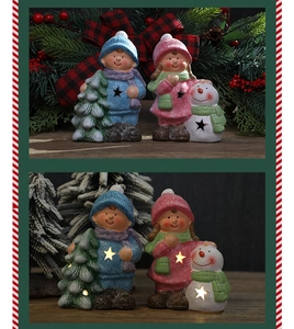 Close-up of glowing ceramic Christmas doll ornaments with LED light star cutouts