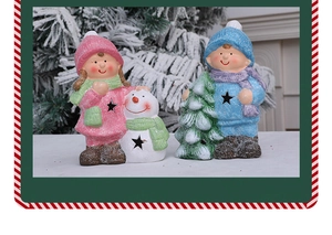 Detail of Christmas figurines with star cutout lights and glittery snow texture