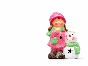 Close-up of a Christmas ceramic girl figurine with star cutouts and snowy texture